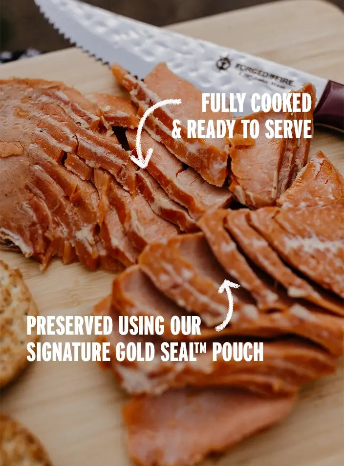 SeaBear Smokehouse | Slices of smoked salmon with crackers on a wooden cutting board.
