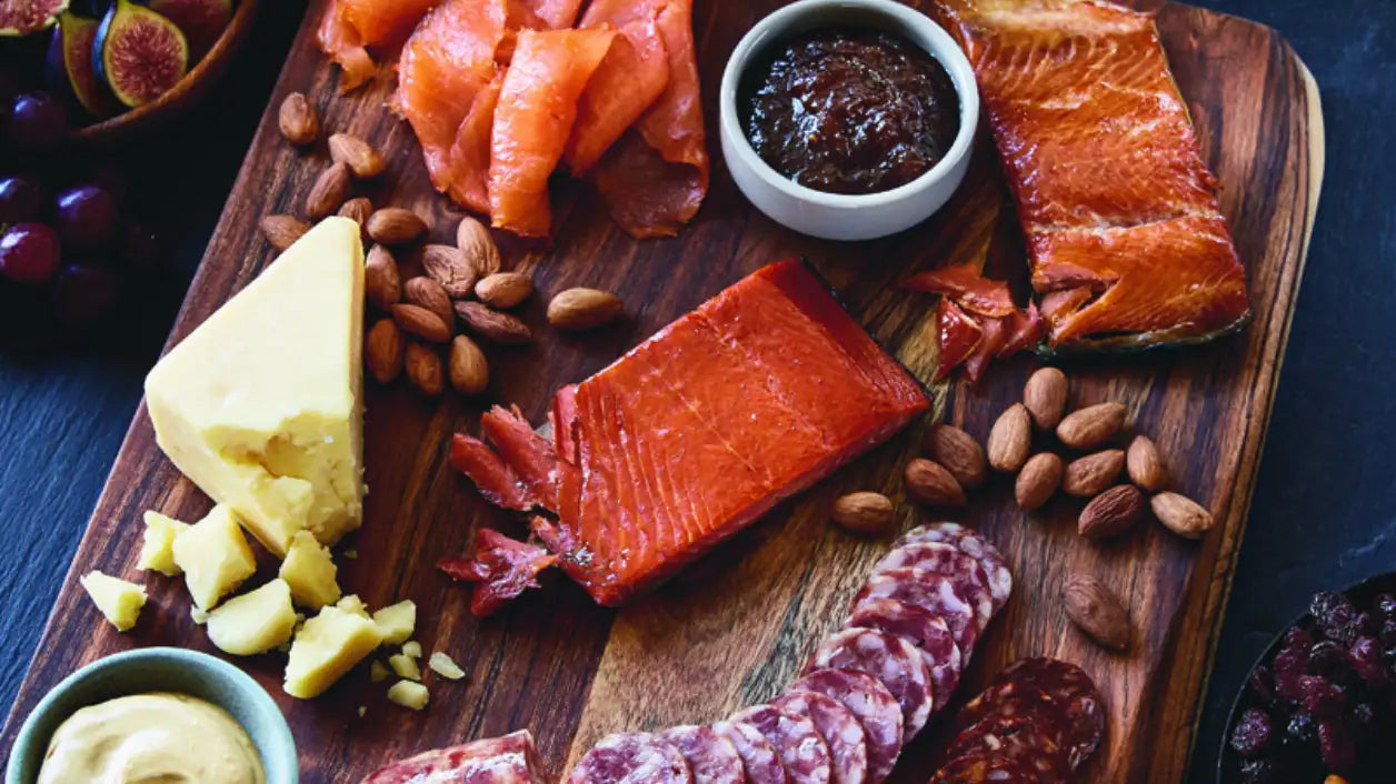 Photograph of full luxury charcuterie board with smoked salmon, trout, nuts, cheese and dips | SeaBear Smokehouse