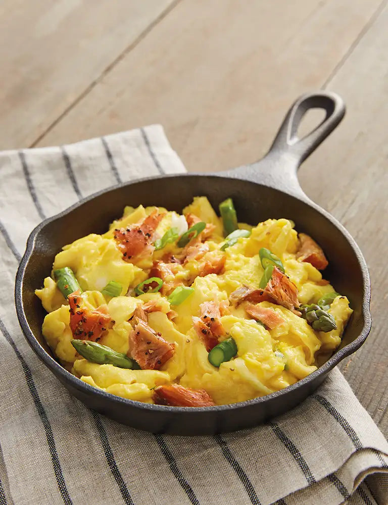 Scrambled eggs with smoked salmon in a skillet