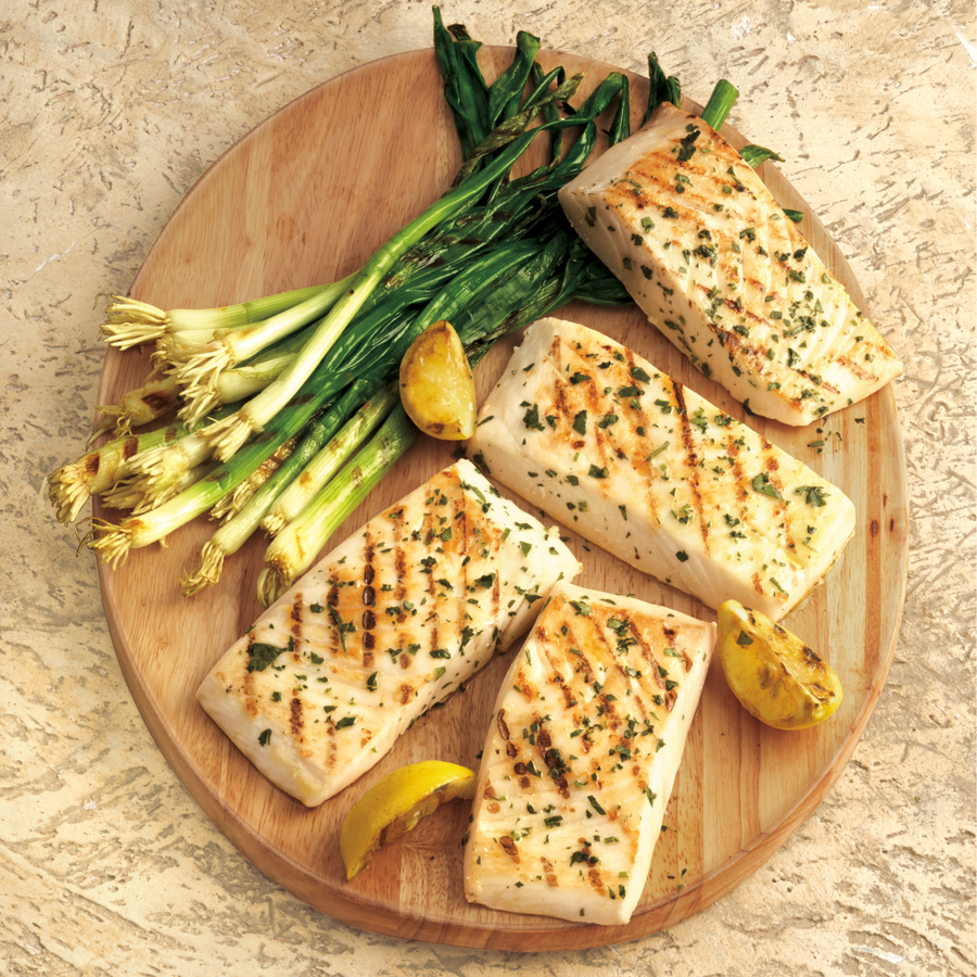 Fresh, Grilled Halibut from Southeast Alaska on a wooden serving board | SeaBear Smokehouse