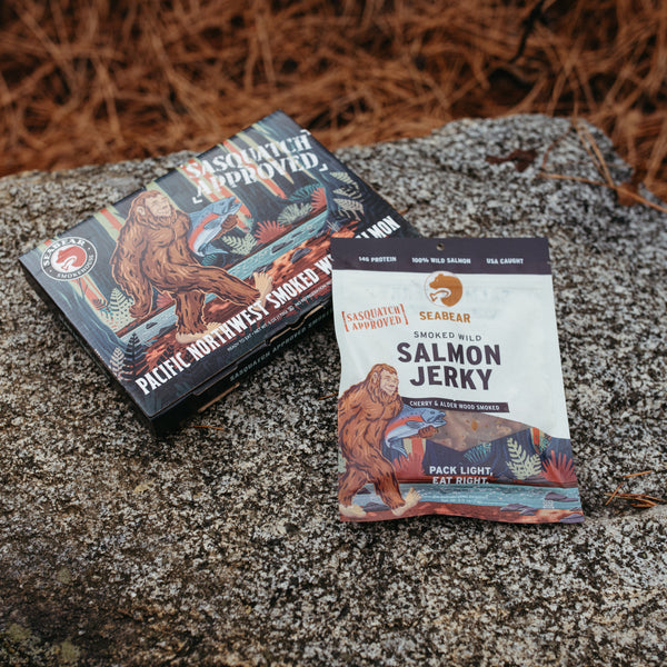 Sasquatch Approved Smoked Salmon Gift Box and Jerky Pack on a rock | SeaBear Smokehouse