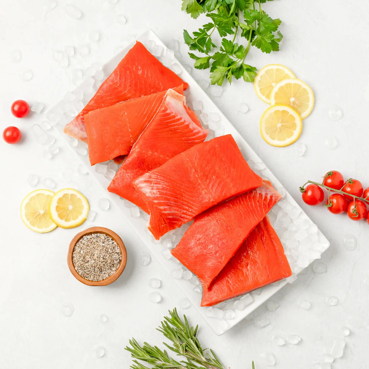 SeaBear | Six wild sockeye salmon dinner fillets over ice.