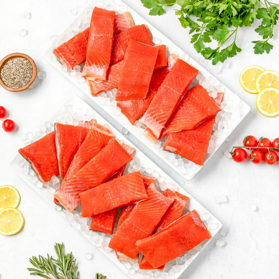 SeaBear | Two trays with layers of wild sockeye salmon lighter meal cut fillets.