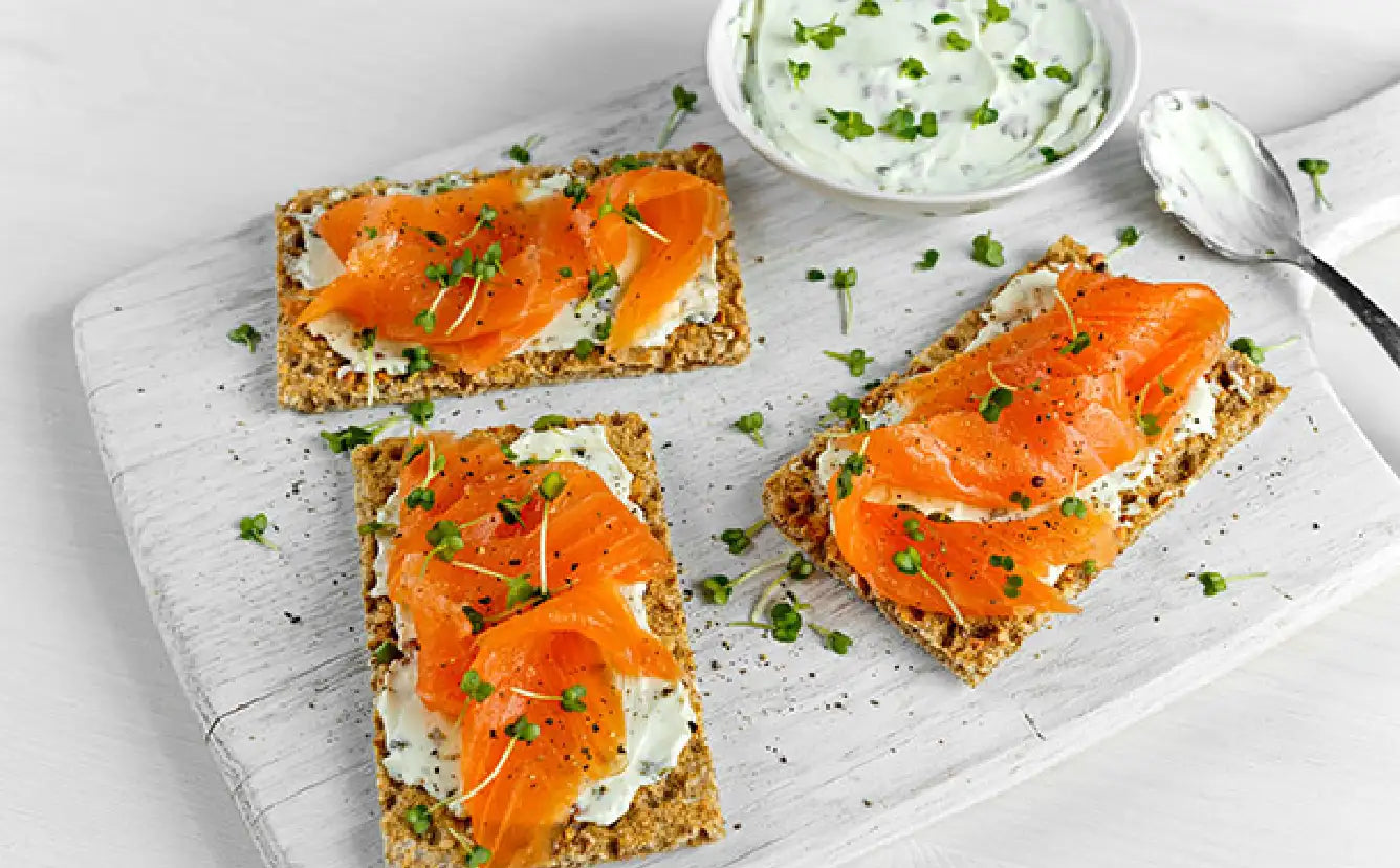 Plated signature smoked salmon lox on cream cheese with crackers | SeaBear Smokehouse