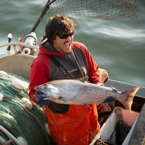 Man Holding a Copper River, Alaska Sockeye Salmon | Fresh & Wild | SeaBear Smokehouse