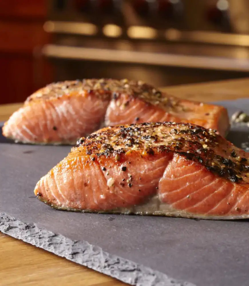 Stone cutting board with baked salmon filets