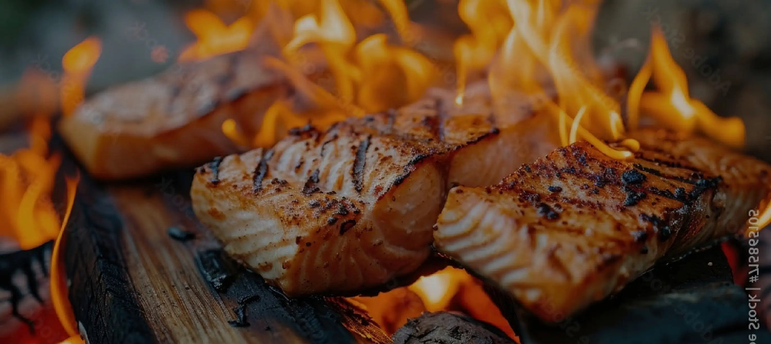 Closeup of fire grilling salmon