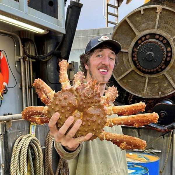 Keyport Crew Member Holding A Crab | SeaBear Smokehouse | Keyport Crab