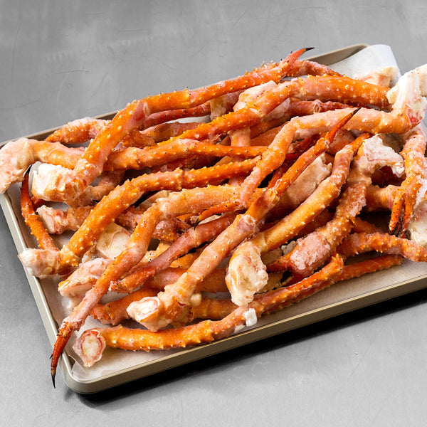 Alaskan Golden King Crab Pieces Spread Out on Tray | SeaBear Smokehouse | Keyport Crab